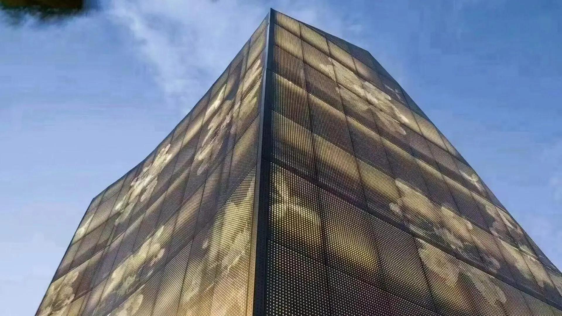 Artistic backlit perforated aluminum panel for exterior facade, custom illuminated metal cladding with decorative light & shadow effect