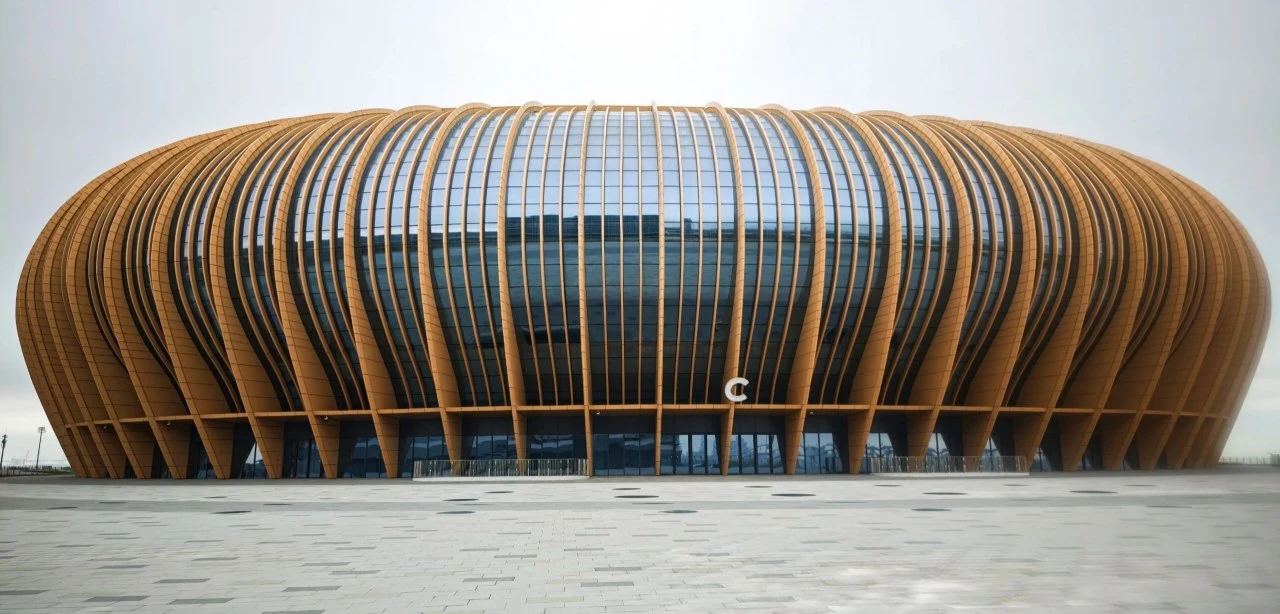 Modern commercial building facade with custom curved aluminum strip cladding