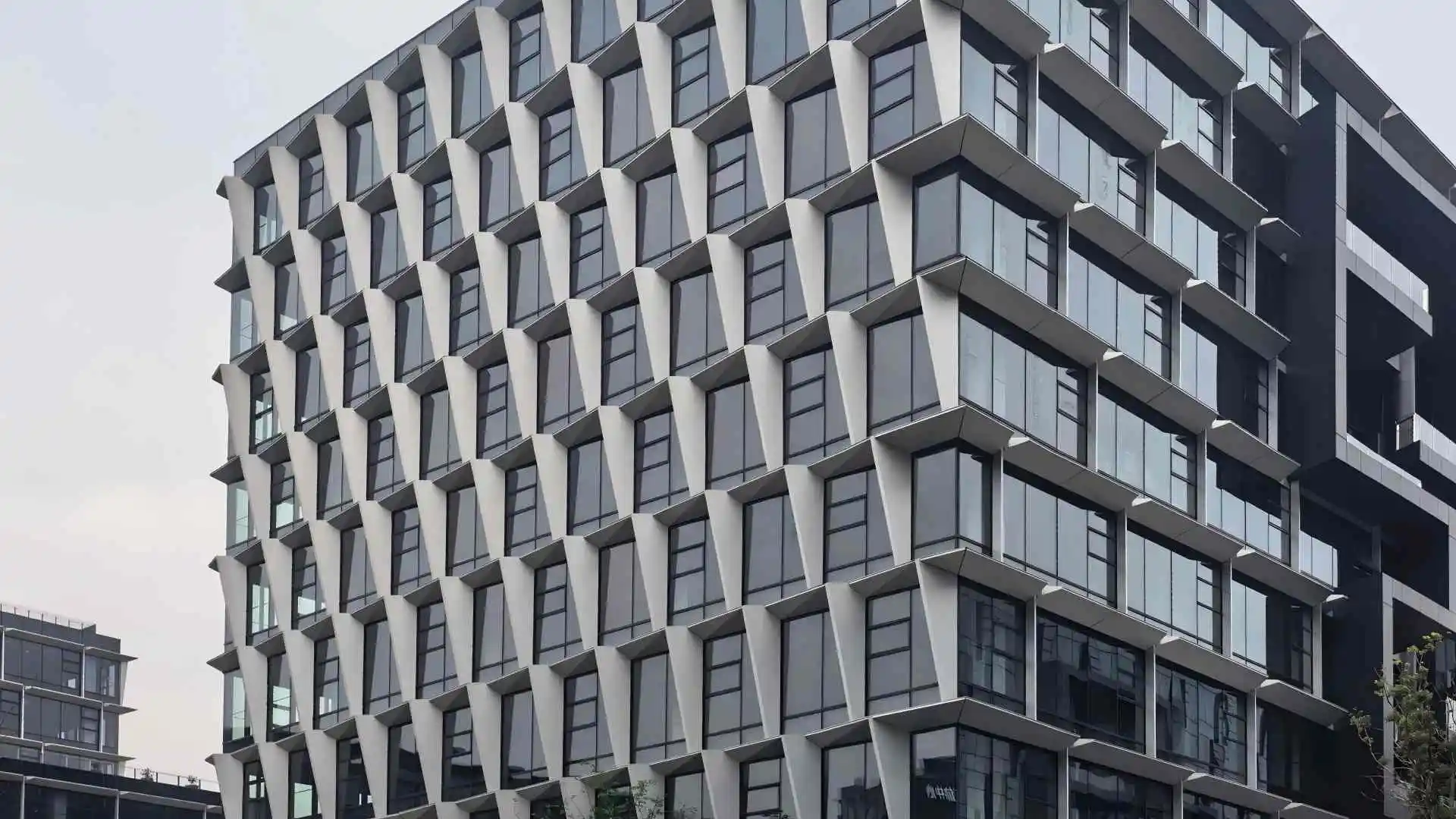 Matte light gray large triangle faceted aluminum facade panels