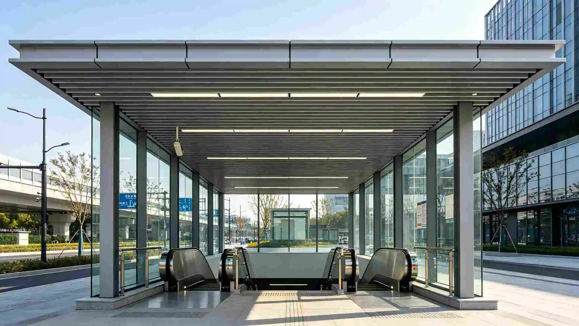 Semi-outdoor linear aluminum canopy ceiling for metro entrance, escalator area, eye level shot
