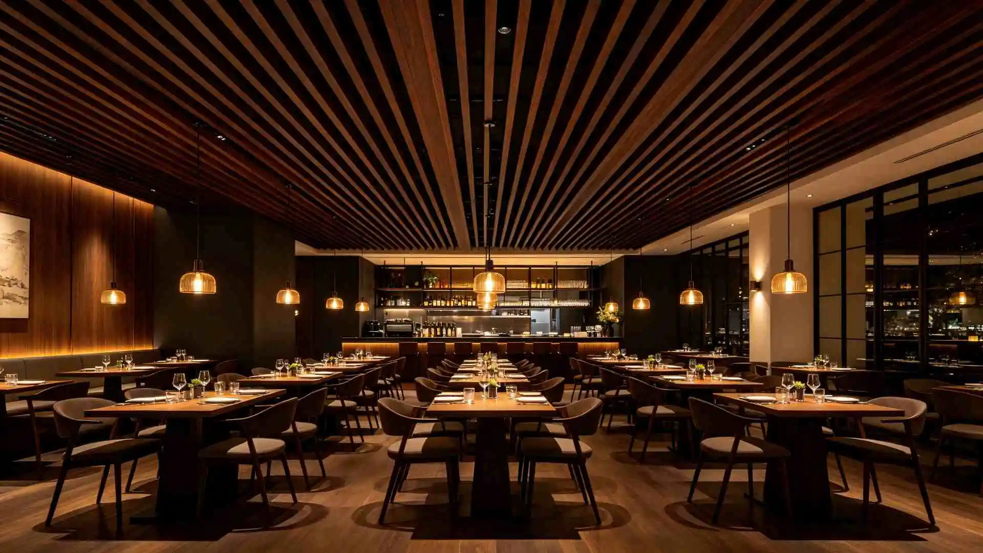 50mm dark walnut strip ceiling in main dining area, paired with warm pendant lighting. The aluminum surface resists cooking grease and smoke, maintaining its original finish after 2 years of daily use.